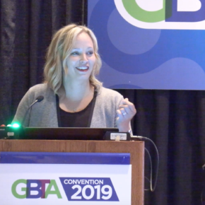 A woman standing at the top of a podium.